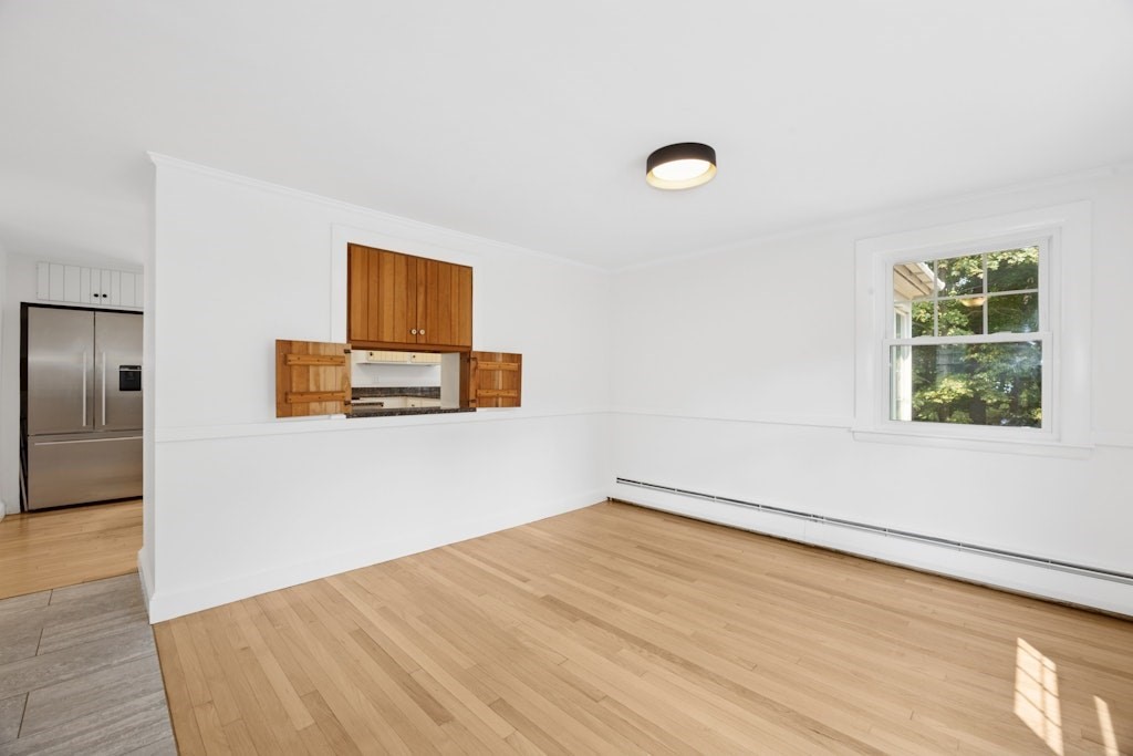 54 Mohawk Drive Acton, MA 01720 - Photo 16 of 42 an empty room with wooden floor cabinet and windows