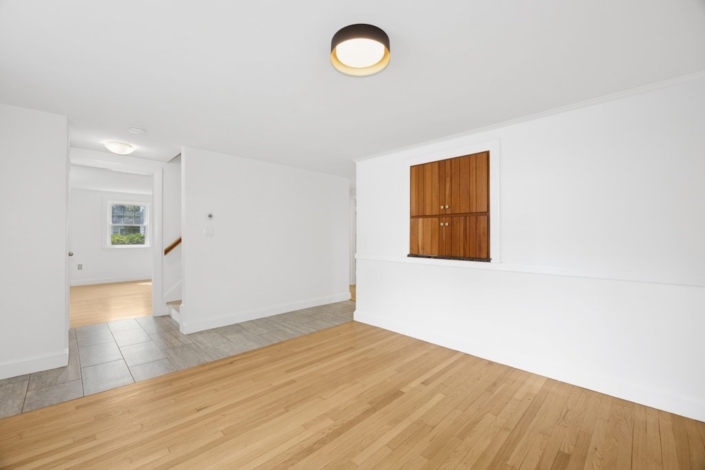 54 Mohawk Drive Acton, MA 01720 - Photo 18 of 42 a view of empty room with wooden floor and fan