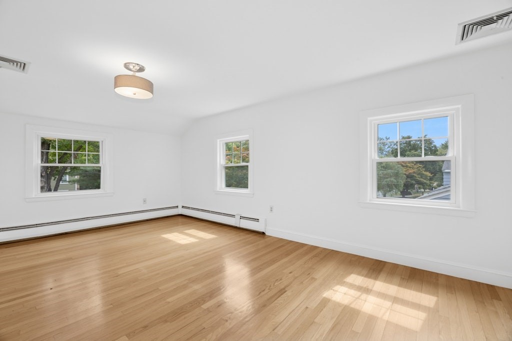 54 Mohawk Drive Acton, MA 01720 - Photo 20 of 42 a view of an empty room with wooden floor and a window