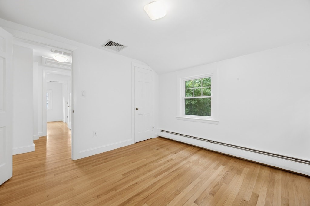 54 Mohawk Drive Acton, MA 01720 - Photo 27 of 42 a view of an empty room with wooden floor and a window