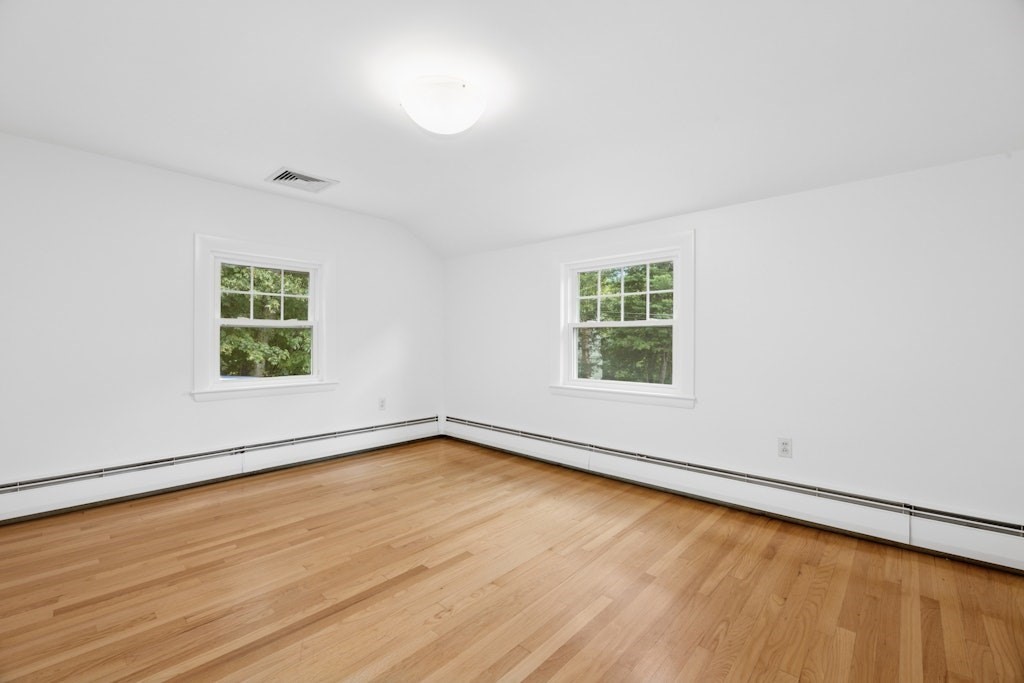 54 Mohawk Drive Acton, MA 01720 - Photo 28 of 42 an empty room with wooden floor and windows