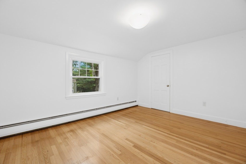 54 Mohawk Drive Acton, MA 01720 - Photo 29 of 42 a view of an empty room with wooden floor and a window