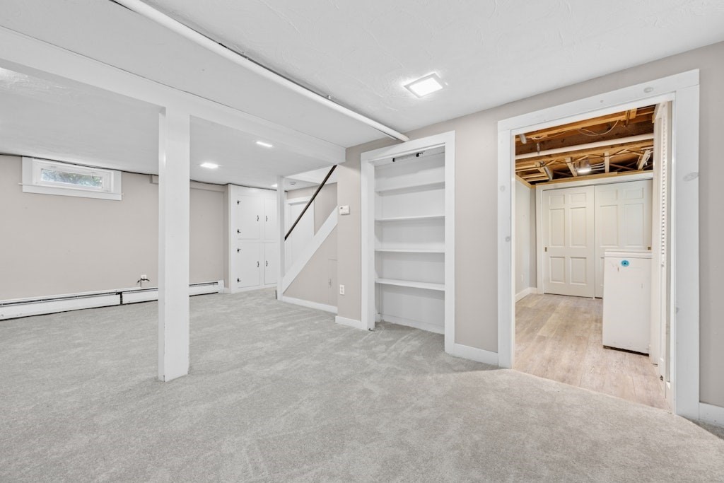 54 Mohawk Drive Acton, MA 01720 - Photo 35 of 42 an empty room with a cabinet and mirrors