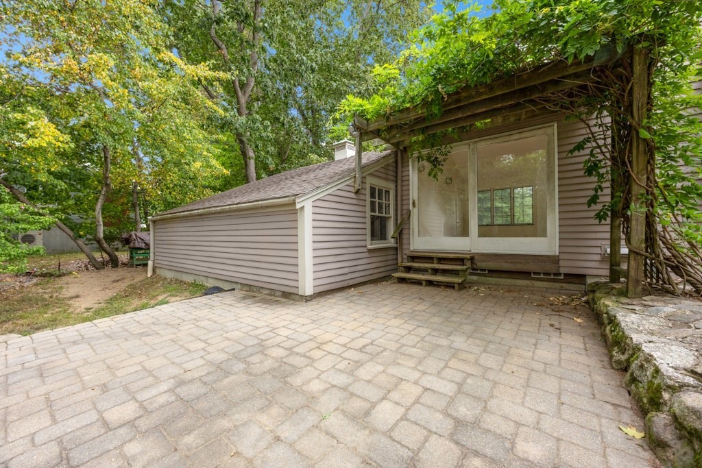 54 Mohawk Drive Acton, MA 01720 - Photo 37 of 42 a backyard of a house with barbeque oven table and chairs