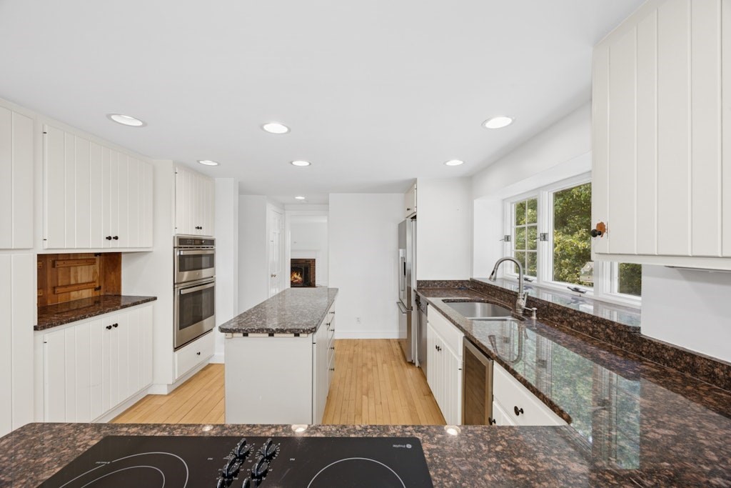 54 Mohawk Drive Acton, MA 01720 - Photo 4 of 42 a kitchen with stainless steel appliances granite countertop a sink and a stove
