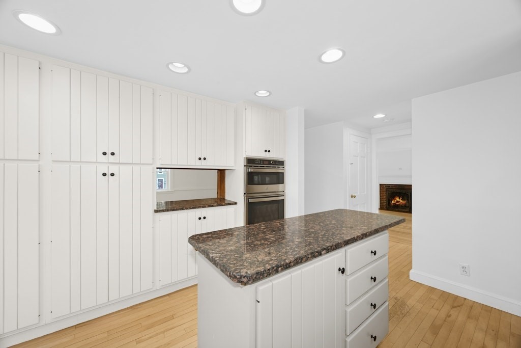 54 Mohawk Drive Acton, MA 01720 - Photo 7 of 42 a kitchen with granite countertop white cabinets and stainless steel appliances