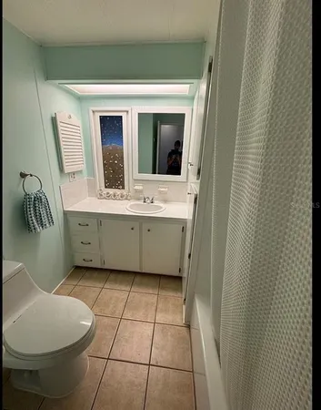 a bathroom with a sink a mirror and bathtub