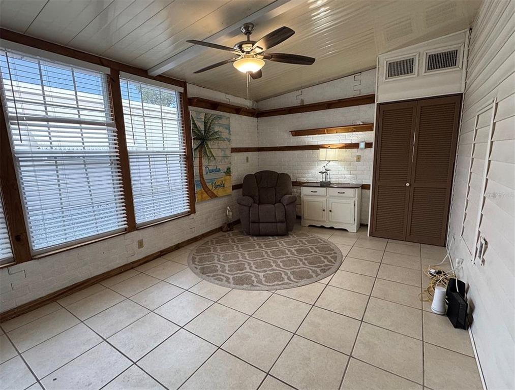3301 Alt 19, Unit 162 Dunedin, FL 34698 - Photo 17 of 23 a room with a large window and chandelier