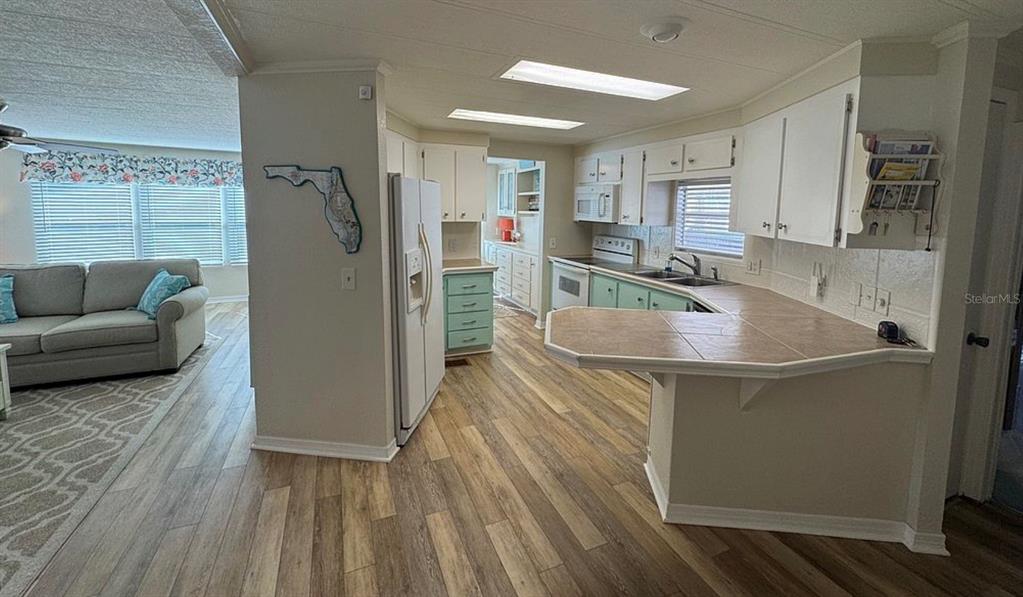 3301 Alt 19, Unit 162 Dunedin, FL 34698 - Photo 2 of 23 a kitchen with stainless steel appliances granite countertop a sink and a refrigerator