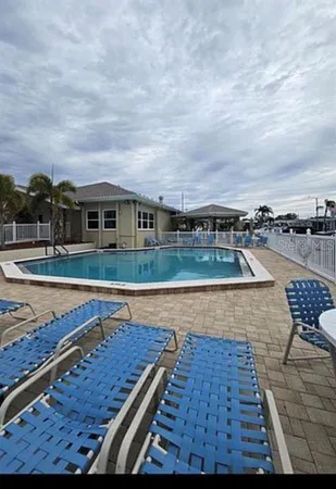 a view of a swimming pool with an outdoor seating