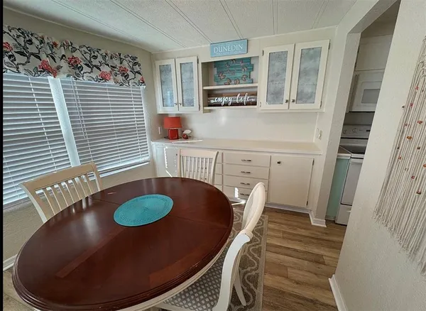 a view of a kitchen area with furniture and wooden floor