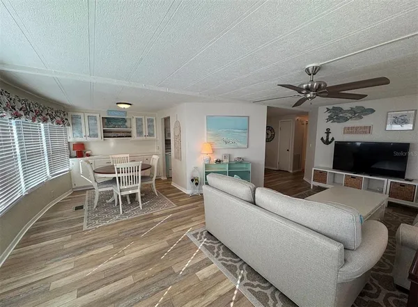 a living room with furniture a flat screen tv and a table