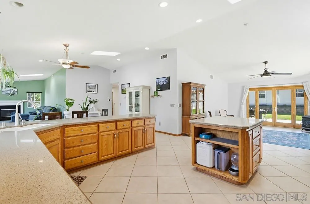 359 Galloway Valley Road Alpine, CA 91901 - Photo 12 of 50 a large kitchen with stainless steel appliances a stove a sink dishwasher and cabinets with wooden floor