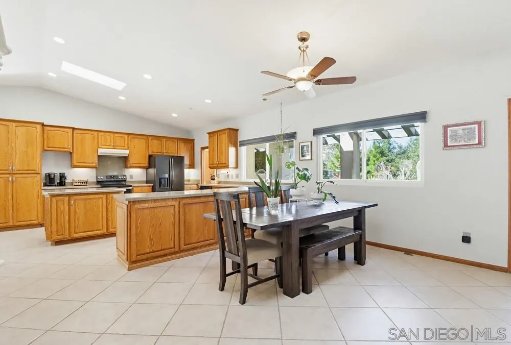 359 Galloway Valley Road Alpine, CA 91901 - Photo 13 of 50 a kitchen with a table chairs microwave and cabinets