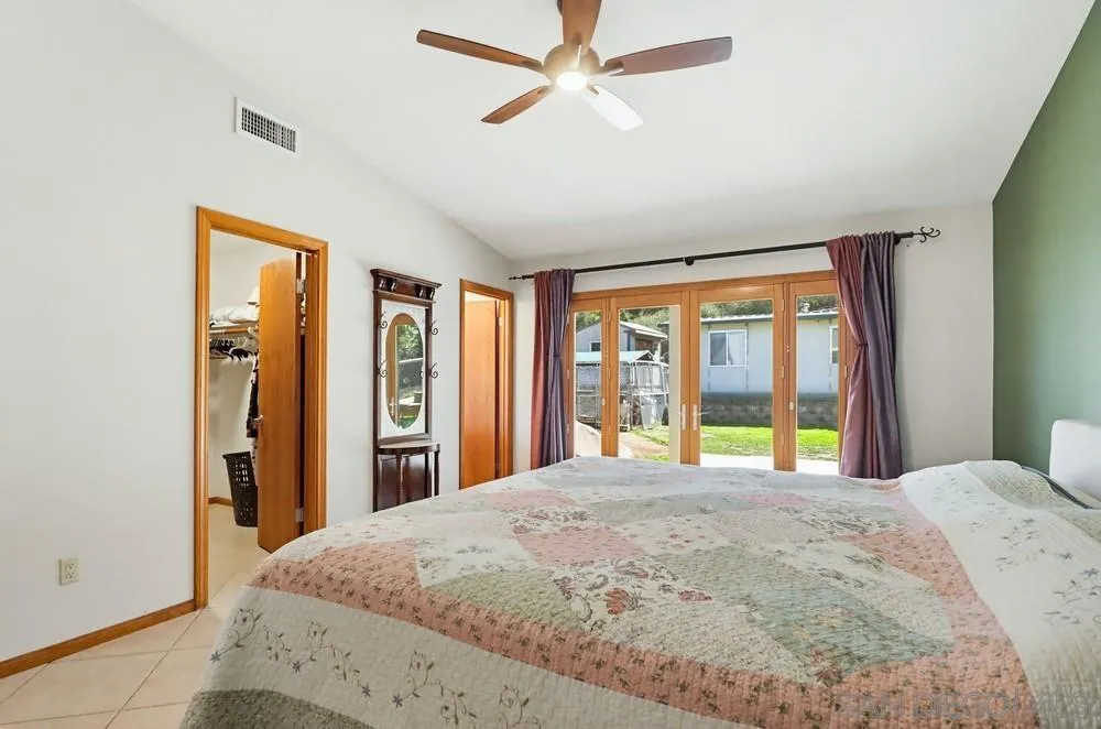 359 Galloway Valley Road Alpine, CA 91901 - Photo 21 of 50 a bedroom with a large bed and a window