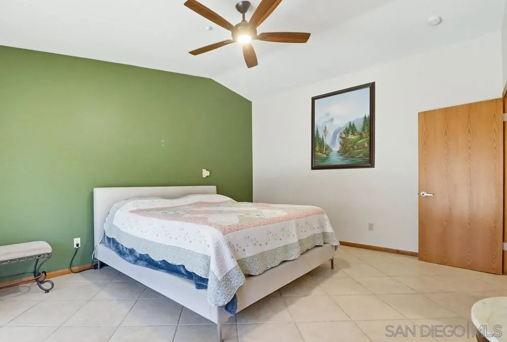 359 Galloway Valley Road Alpine, CA 91901 - Photo 22 of 50 a bedroom with a bed and a chandelier