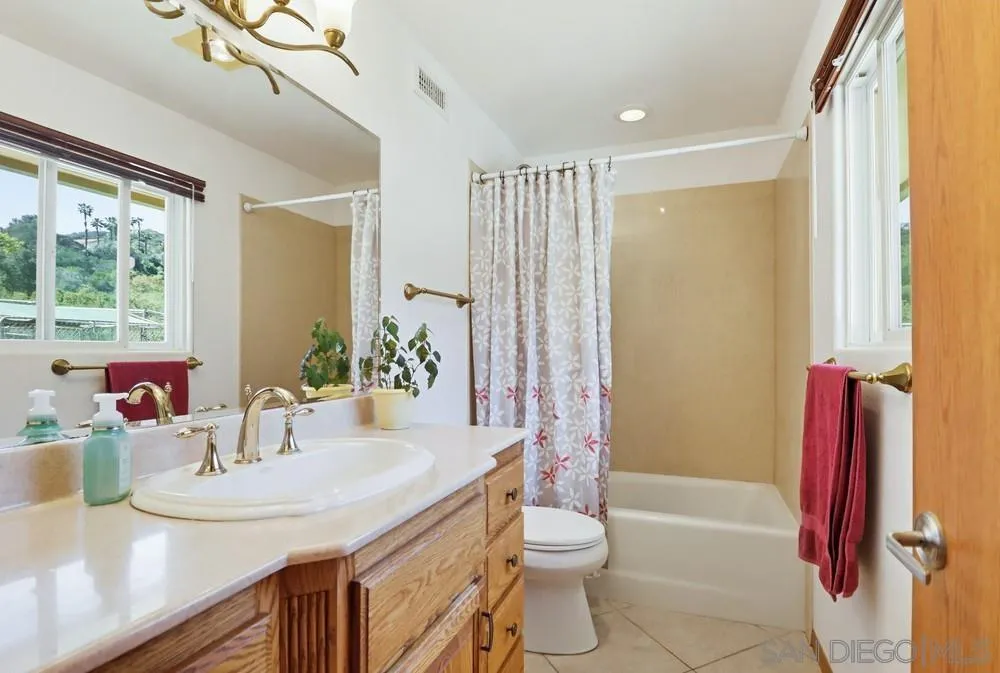 359 Galloway Valley Road Alpine, CA 91901 - Photo 26 of 50 a bathroom with a granite countertop sink and a mirror