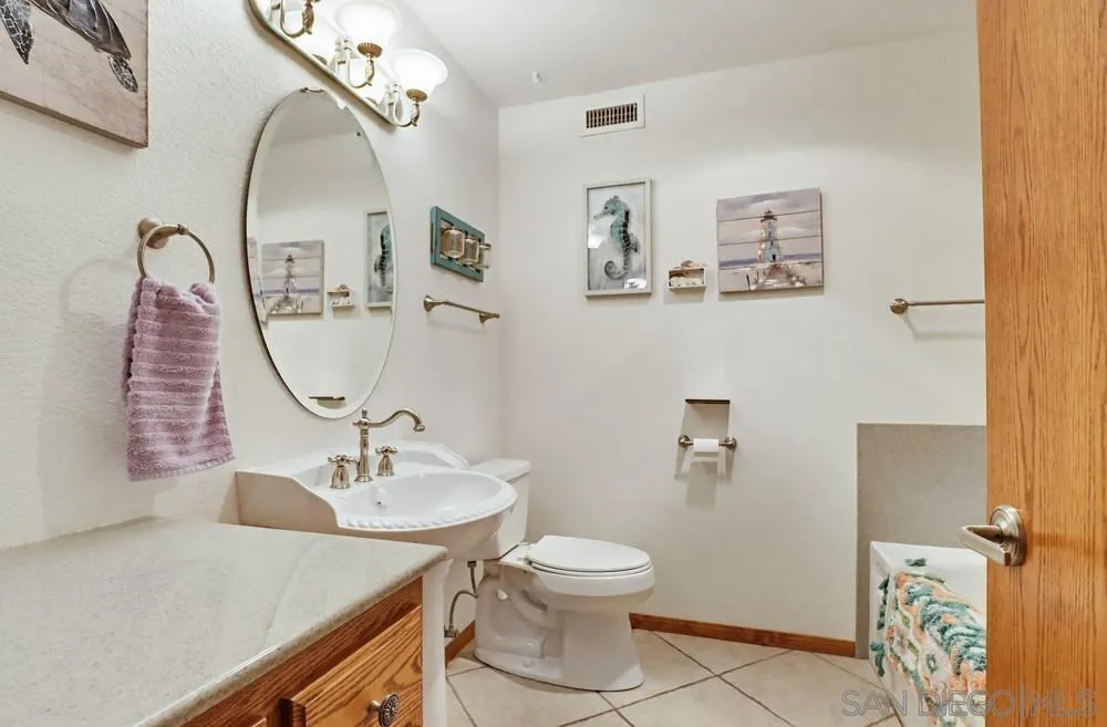 359 Galloway Valley Road Alpine, CA 91901 - Photo 28 of 50 a bathroom with a sink a toilet and a mirror