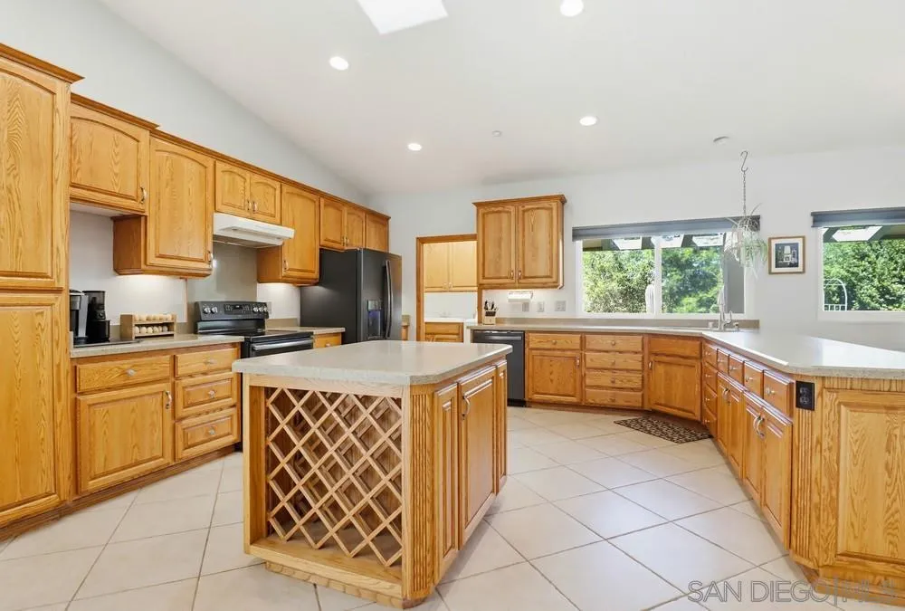 359 Galloway Valley Road Alpine, CA 91901 - Photo 7 of 50 a kitchen with stainless steel appliances granite countertop a stove a sink and a refrigerator