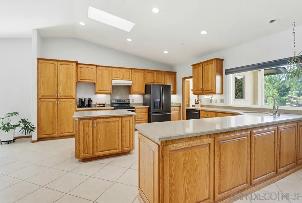 359 Galloway Valley Road Alpine, CA 91901 - Photo 9 of 50 a kitchen with sink a refrigerator and cabinets