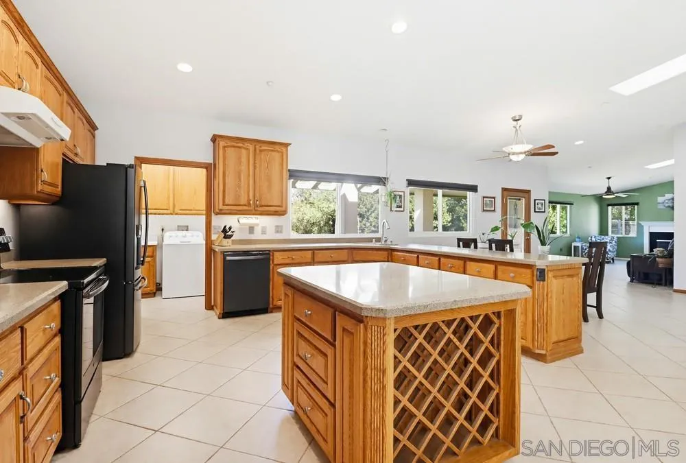 359 Galloway Valley Road Alpine, CA 91901 - Photo 10 of 50 a kitchen with stainless steel appliances granite countertop a sink and a refrigerator