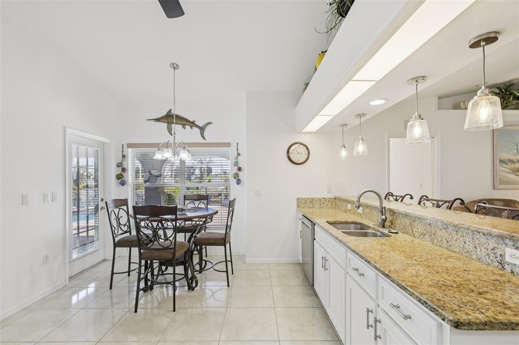 257 Medalist Road Rotonda West, FL 33947 - Photo 12 of 32 a bathroom with a granite countertop sink and a large mirror