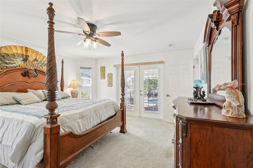 257 Medalist Road Rotonda West, FL 33947 - Photo 14 of 32 a bedroom with a bed and a chandelier