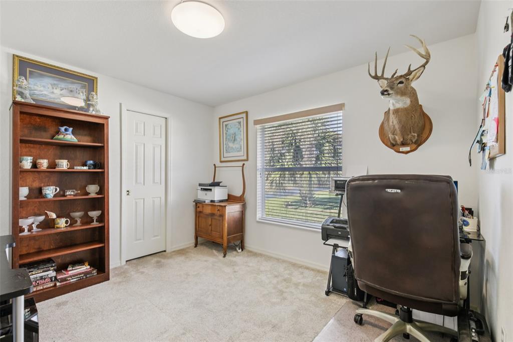 257 Medalist Road Rotonda West, FL 33947 - Photo 18 of 32 a view of a workspace with furniture and a window
