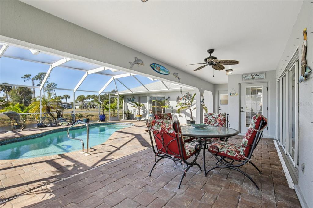 257 Medalist Road Rotonda West, FL 33947 - Photo 21 of 32 a view of a dining room with furniture one side kitchen view and a wooden floor
