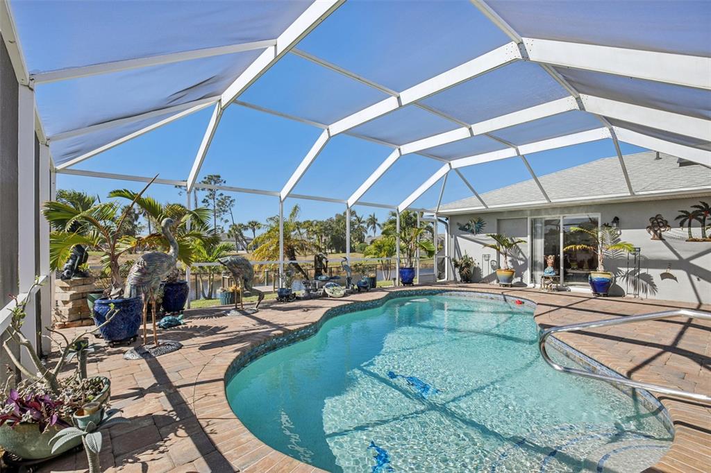 257 Medalist Road Rotonda West, FL 33947 - Photo 23 of 32 a view of a swimming pool with a patio