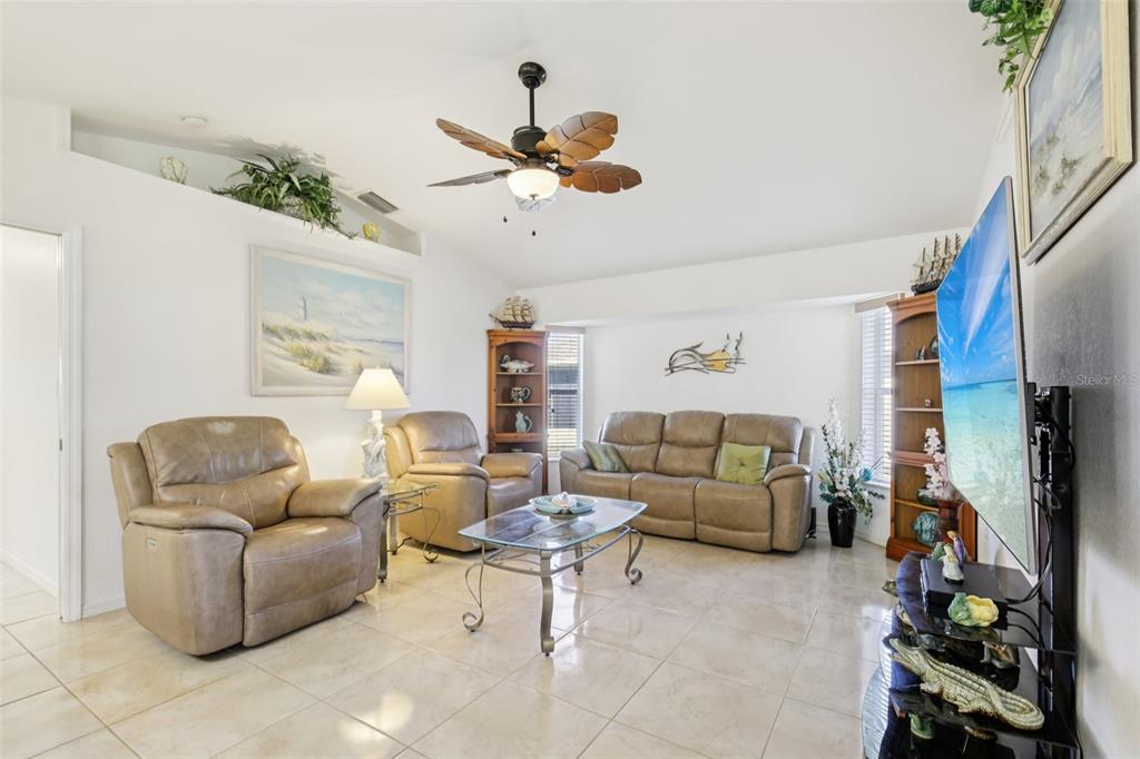 257 Medalist Road Rotonda West, FL 33947 - Photo 3 of 32 a living room with furniture and a flat screen tv
