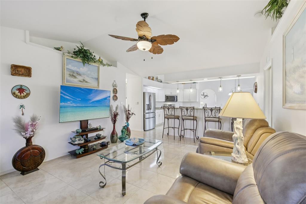 257 Medalist Road Rotonda West, FL 33947 - Photo 4 of 32 a living room with furniture a window and a chandelier