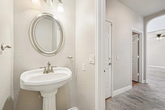 an empty room with a window and ceiling fan