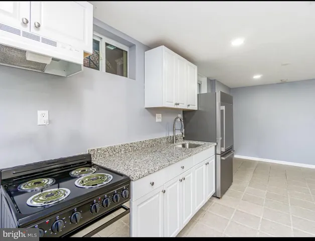 a kitchen with a stove and a sink