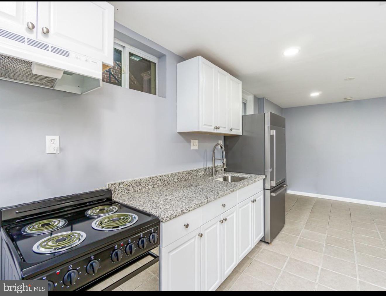a kitchen with a stove and a sink