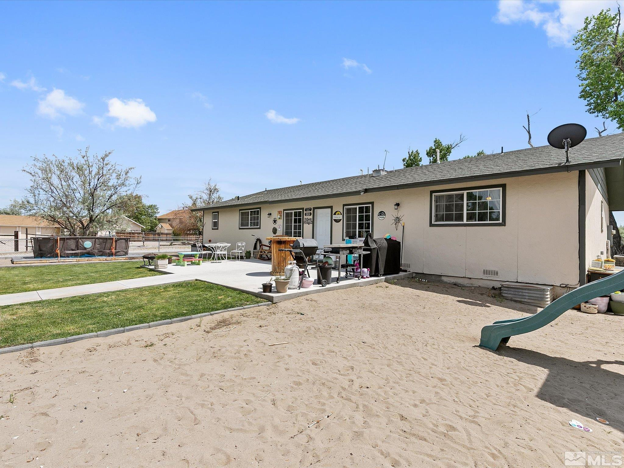 660 Northview Drive Fallon, NV 89406 - Photo 26 of 33 a view of a backyard with table and chairs under an umbrella