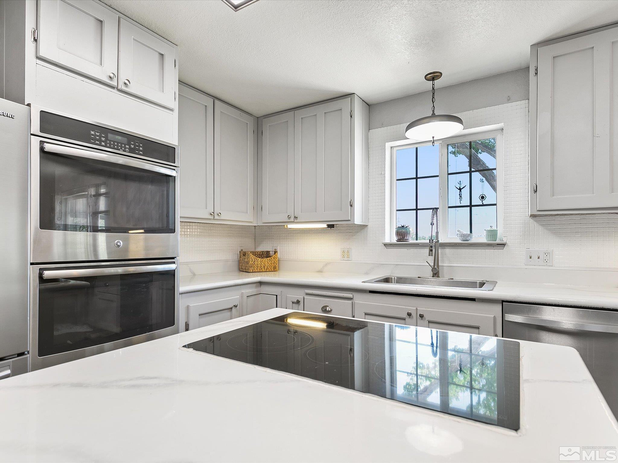 660 Northview Drive Fallon, NV 89406 - Photo 9 of 33 a kitchen with stainless steel appliances granite countertop a stove and a sink