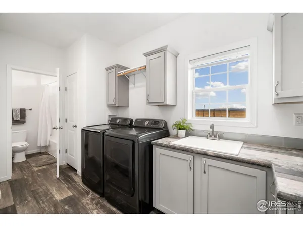 a kitchen with a sink cabinets and a window