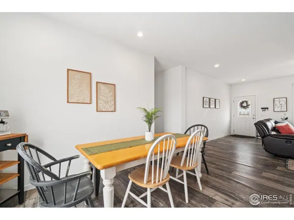 a dining room with furniture and wooden floor