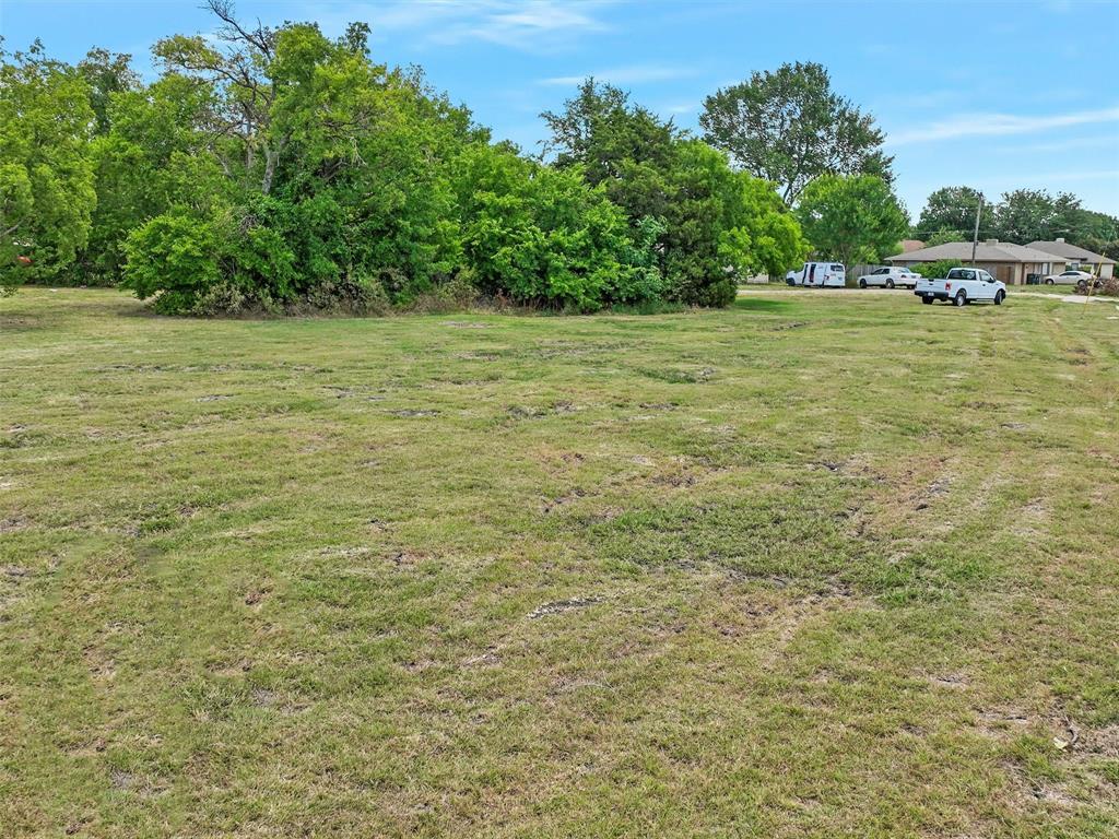 2202 Rowlett Road Garland, TX 75043 - Photo 8 of 16 a view of a field with trees in the background
