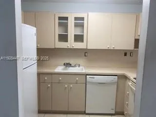 a kitchen with cabinets appliances and a sink