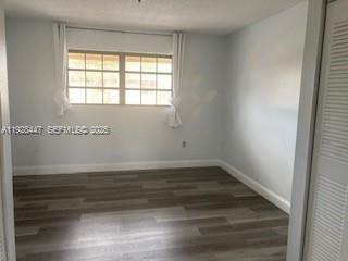 13320 Southwest 60th Terrace Miami, FL 33183 - Photo 9 of 14 a view of an empty room with wooden floor and a window