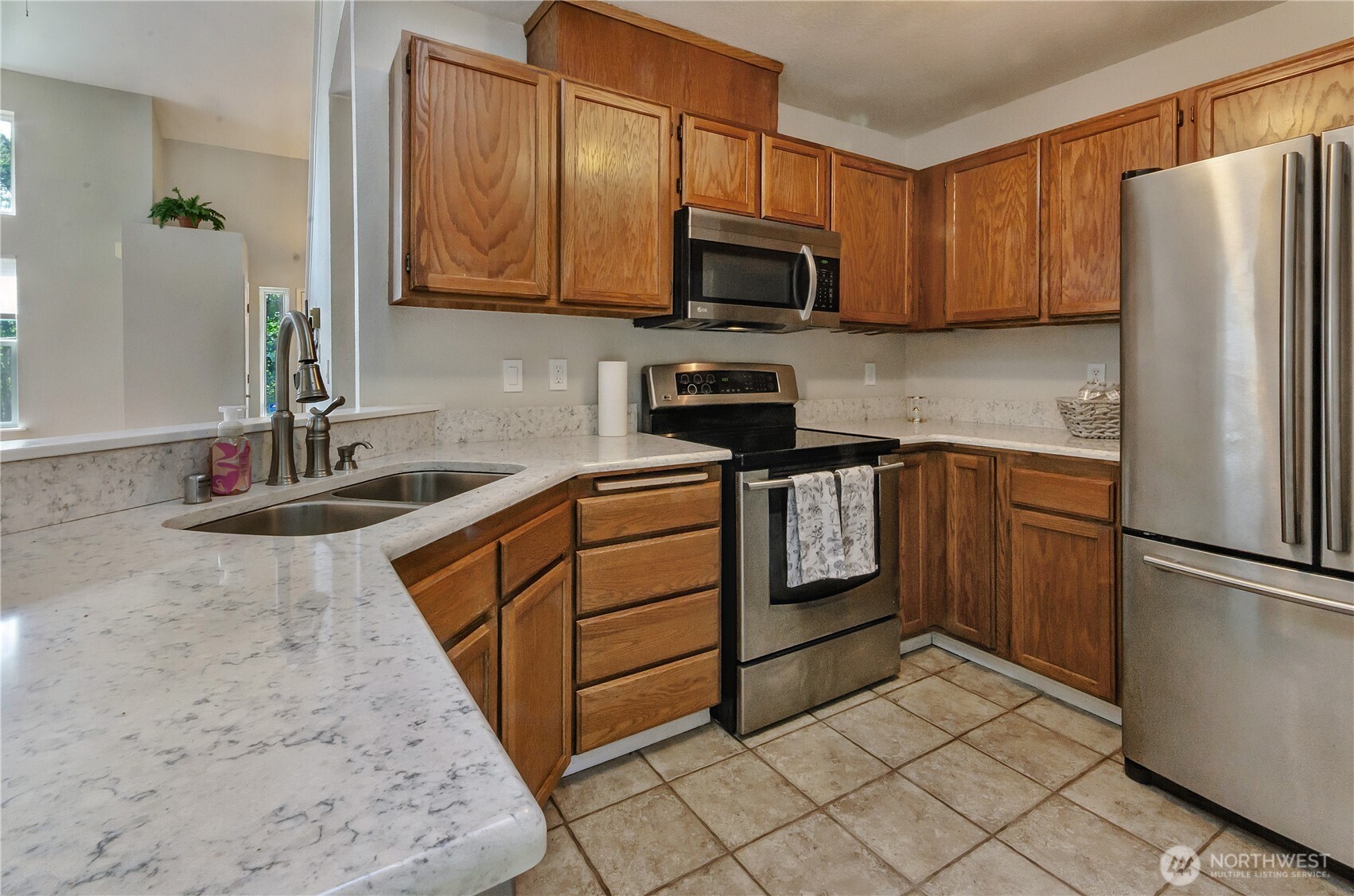 5214 78th Court Southwest Olympia, WA 98512 - Photo 8 of 27 a kitchen with stainless steel appliances granite countertop a refrigerator stove a sink and dishwasher