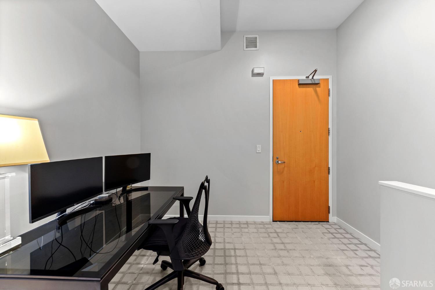 333 Main Street, Unit 2A San Francisco, CA 94105 - Photo 16 of 24 a view of a workspace with furniture and a flat screen tv