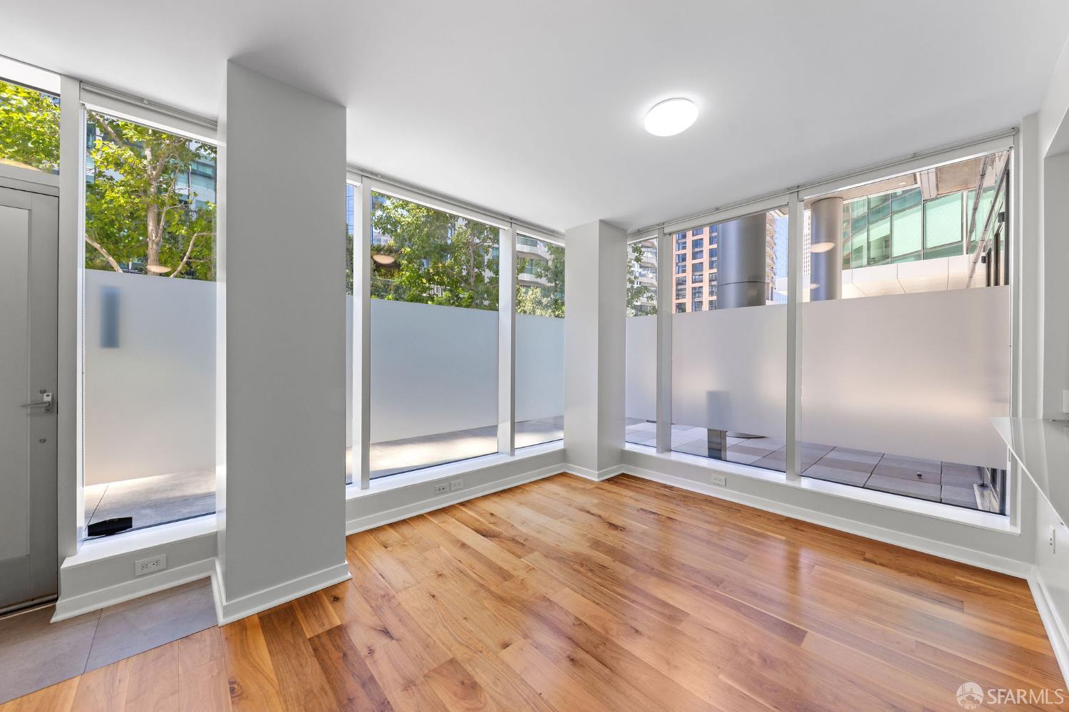 333 Main Street, Unit 2A San Francisco, CA 94105 - Photo 2 of 24 an empty room with wooden floor and windows