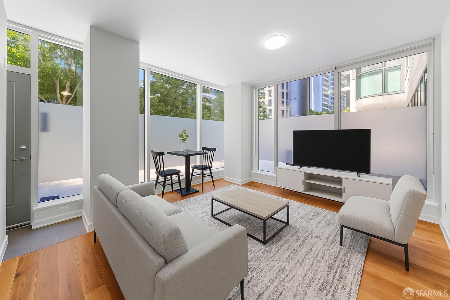 333 Main Street, Unit 2A San Francisco, CA 94105 - Photo 3 of 24 a living room with furniture and a flat screen tv