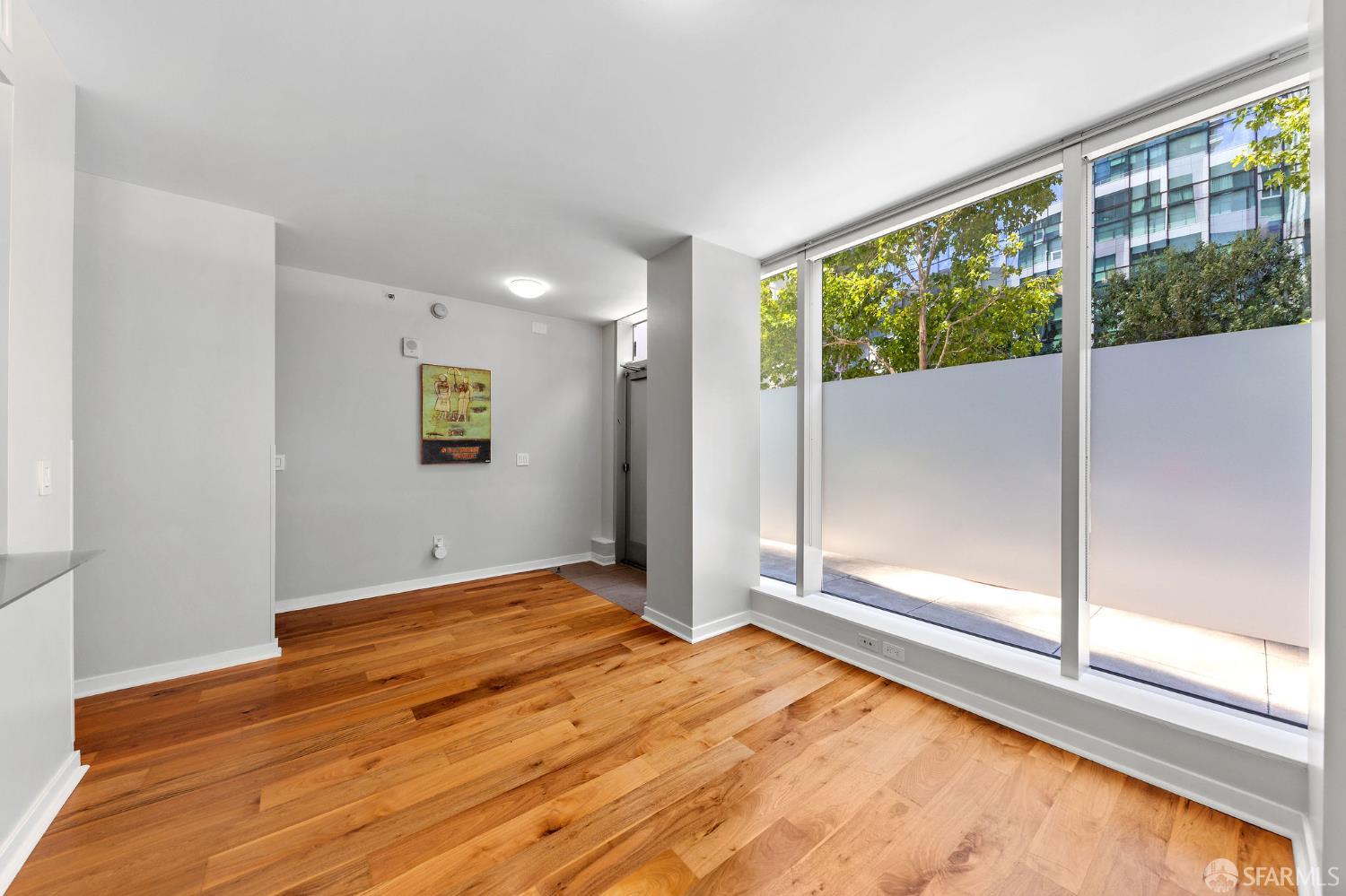 333 Main Street, Unit 2A San Francisco, CA 94105 - Photo 4 of 24 a view of an empty room with wooden floor and a window