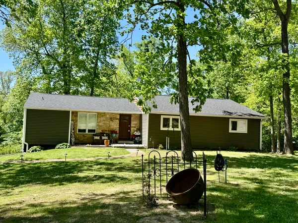a backyard of a house with yard table and chairs