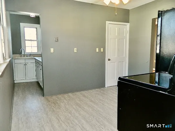 a view of empty room with wooden floor