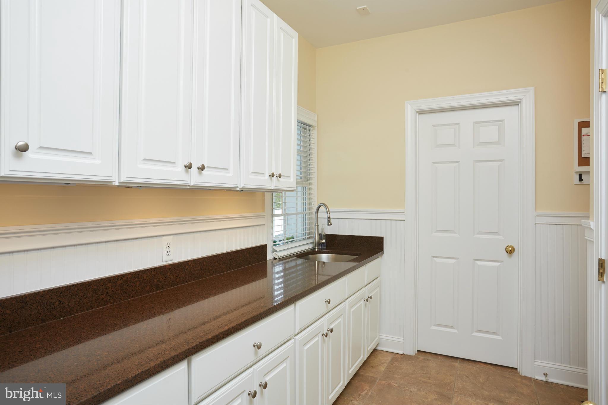 12636 Greenbriar Road Potomac, MD 20854 - Photo 12 of 30 a kitchen with granite countertop white cabinets and sink